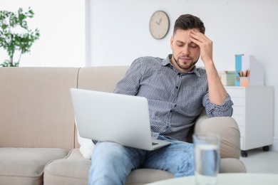 Man suffering from headache at home