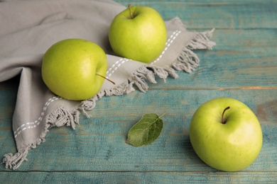 Photo of Fresh ripe green apples on blue wooden table