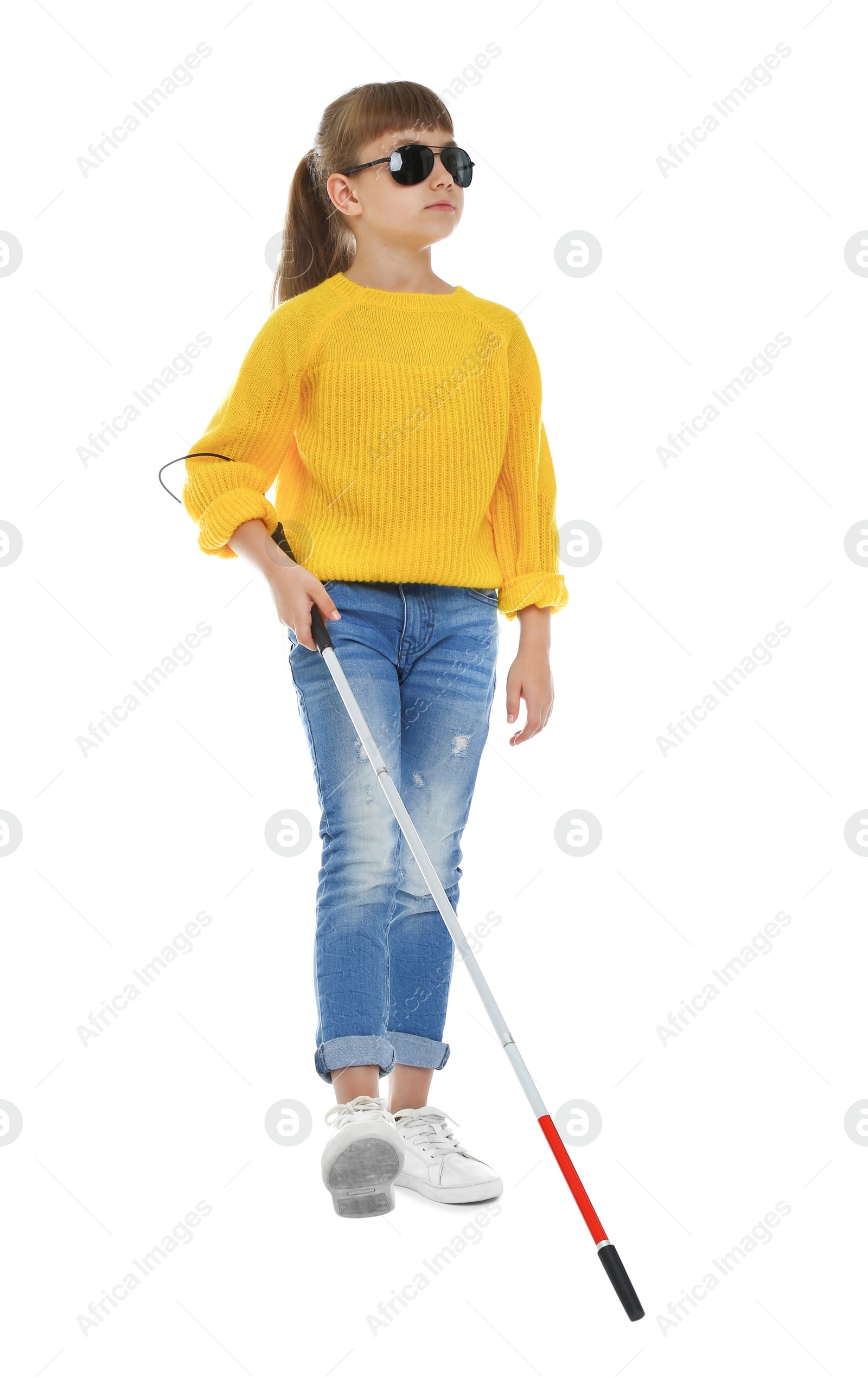 Photo of Blind girl with long cane walking on white background