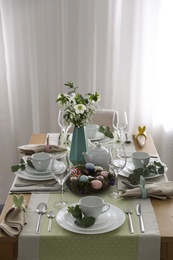 Photo of Beautiful Easter table setting with festive decor indoors