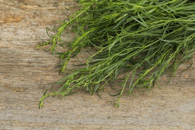 Fresh tarragon sprigs on wooden table. Space for text