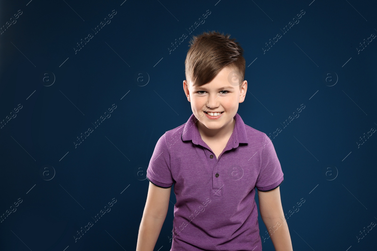 Photo of Portrait of emotional little boy on color background