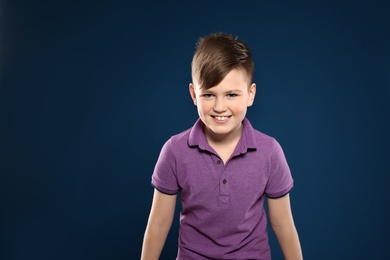 Portrait of emotional little boy on color background