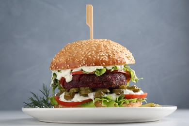 Photo of Vegetarian burger with delicious patty on white table, closeup