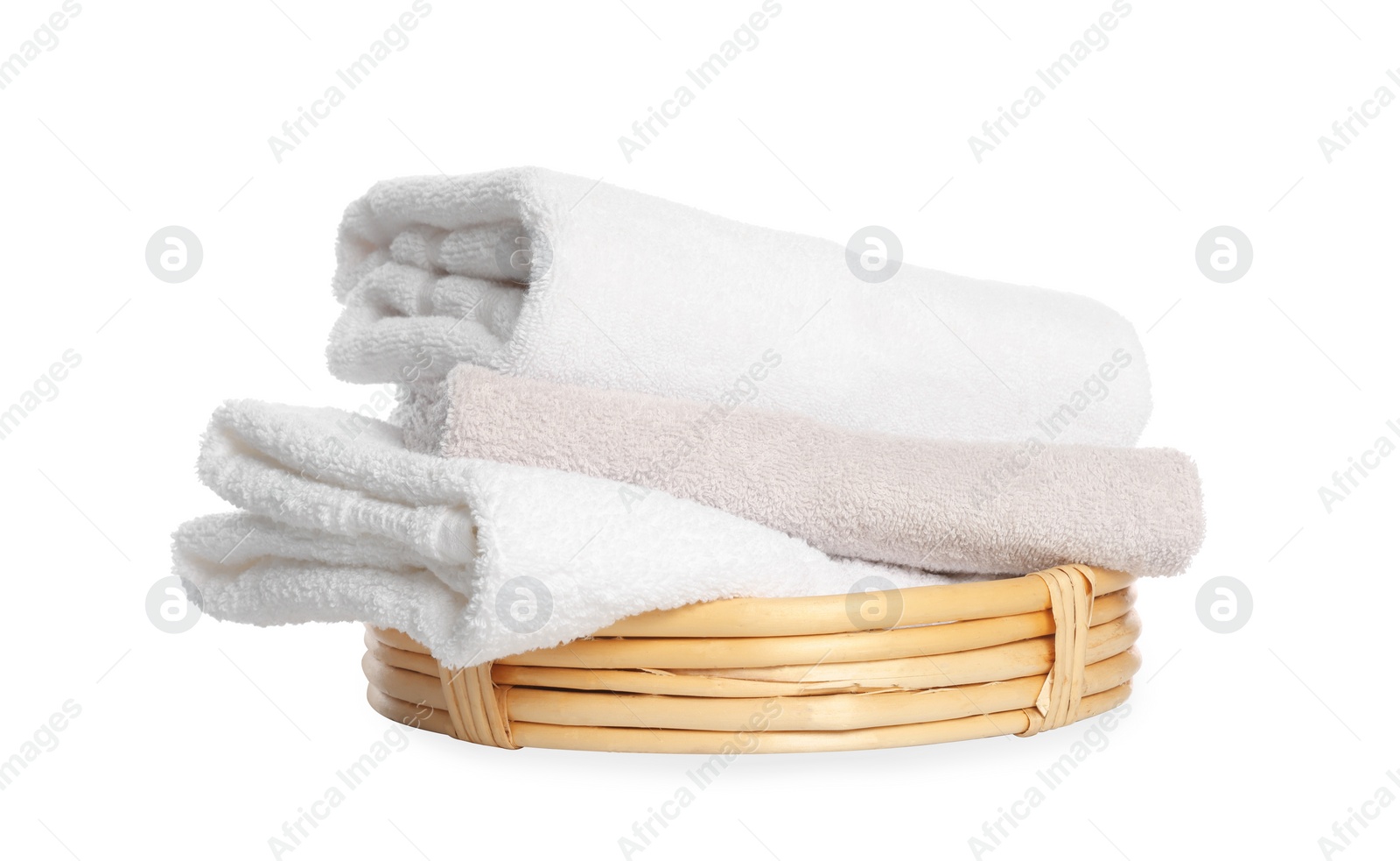 Photo of Wicker basket with folded bath towels isolated on white