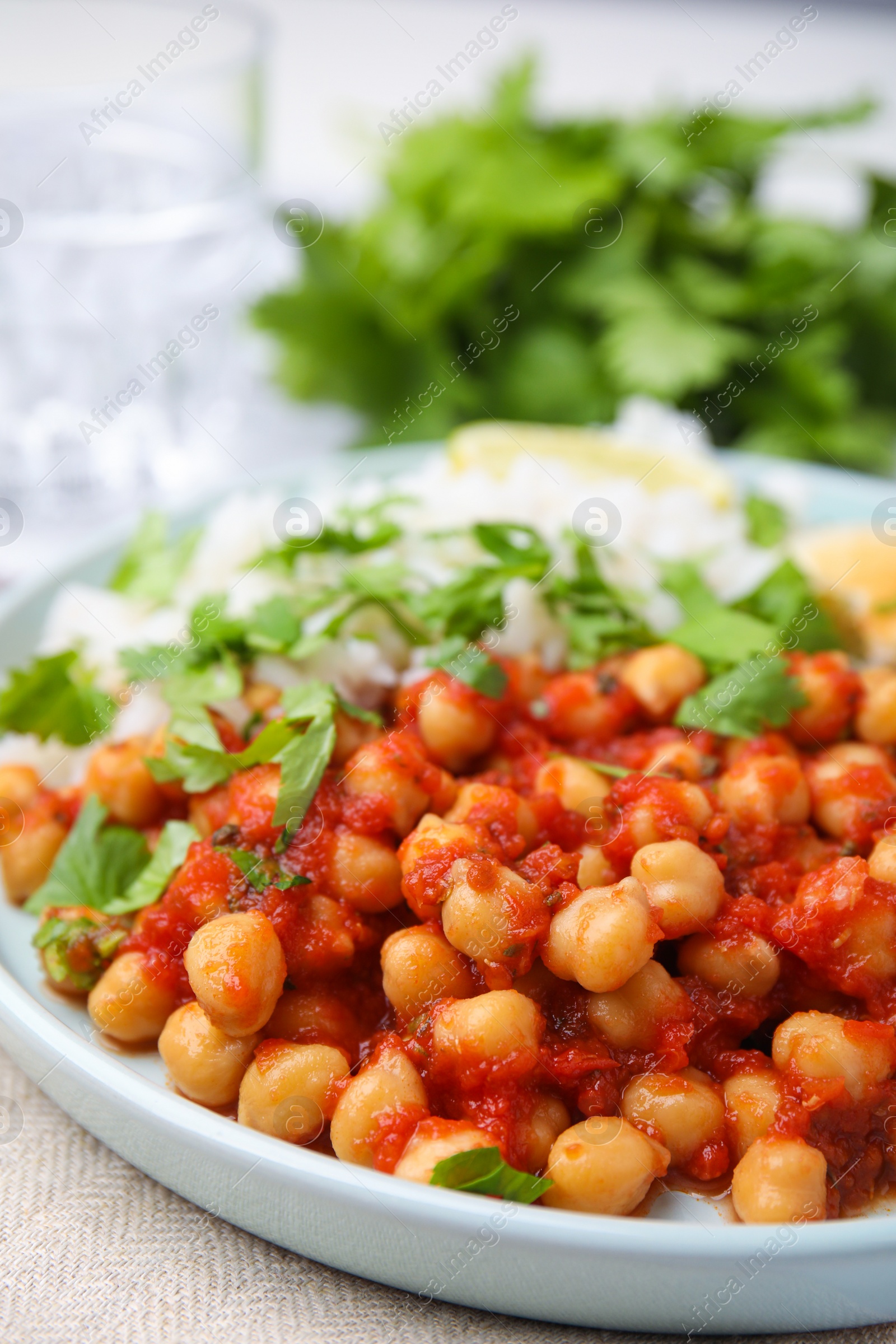 Photo of Plate with delicious chickpea curry on table, closeup