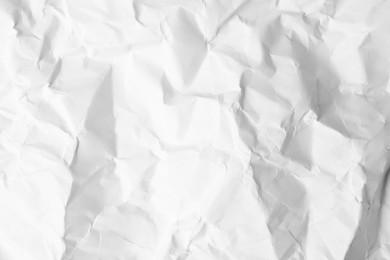 Photo of Sheet of crumpled paper white as background, top view