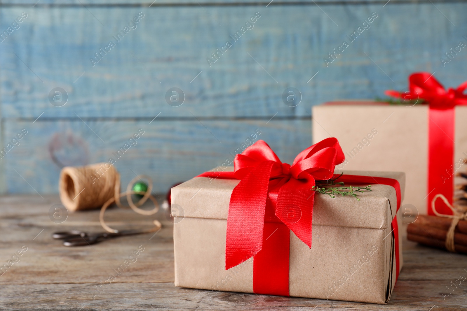 Photo of Christmas gifts on table against blue wooden background