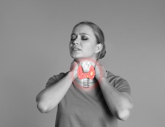 Woman with thyroid gland disease on grey background