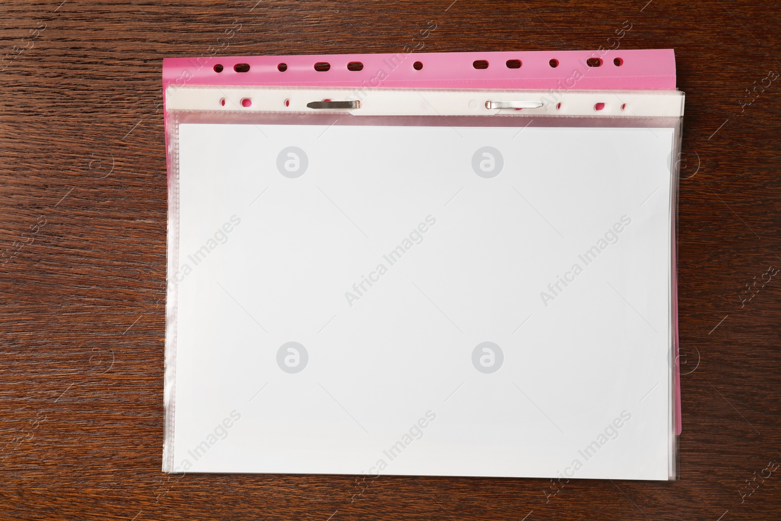 Photo of File folder with punched pockets on wooden table, top view. Space for text