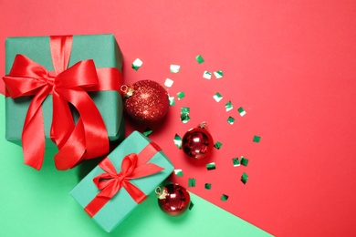 Photo of Gift boxes and Christmas decorations on color background, flat lay. Space for text