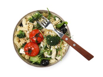 Bowl of delicious pasta with tomatoes, broccoli and cheese on white background, top view
