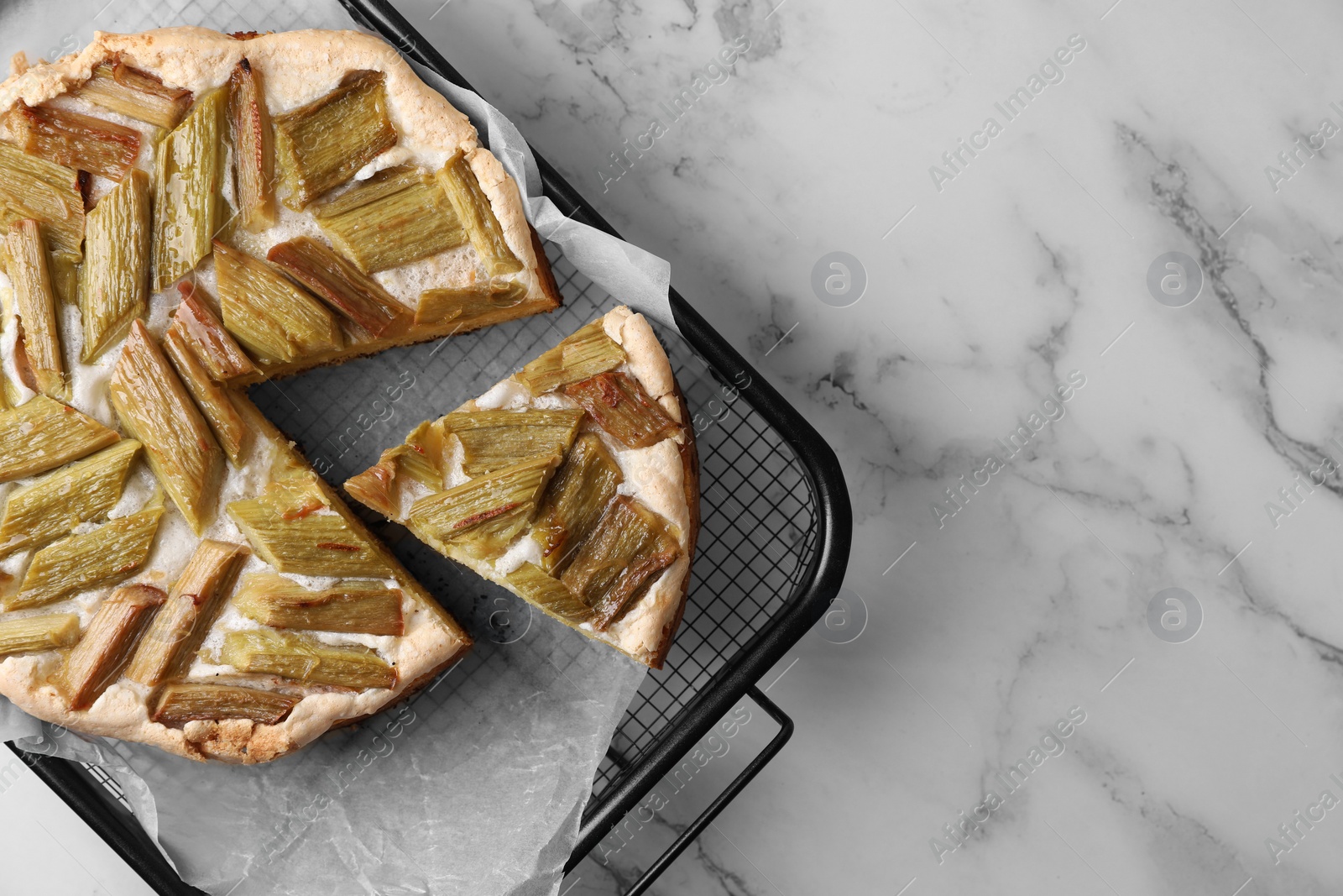 Photo of Freshly baked rhubarb pie on white marble table, top view. Space for text