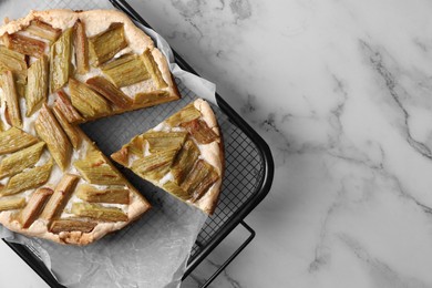 Freshly baked rhubarb pie on white marble table, top view. Space for text