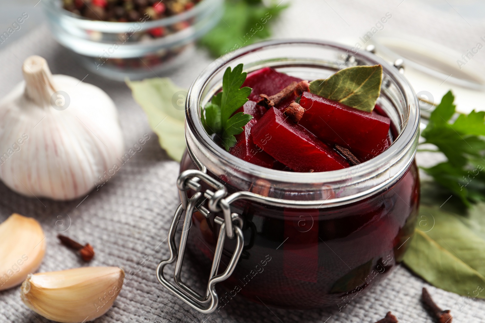 Photo of Delicious pickled beets and spices on table, closeup