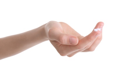 Young woman applying hand cream against on white background