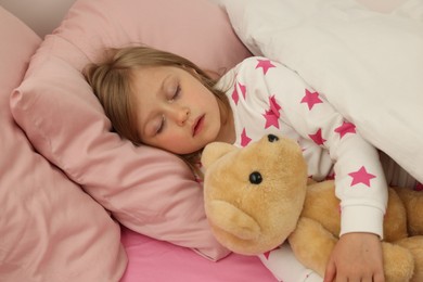 Photo of Little girl snoring while sleeping in bed