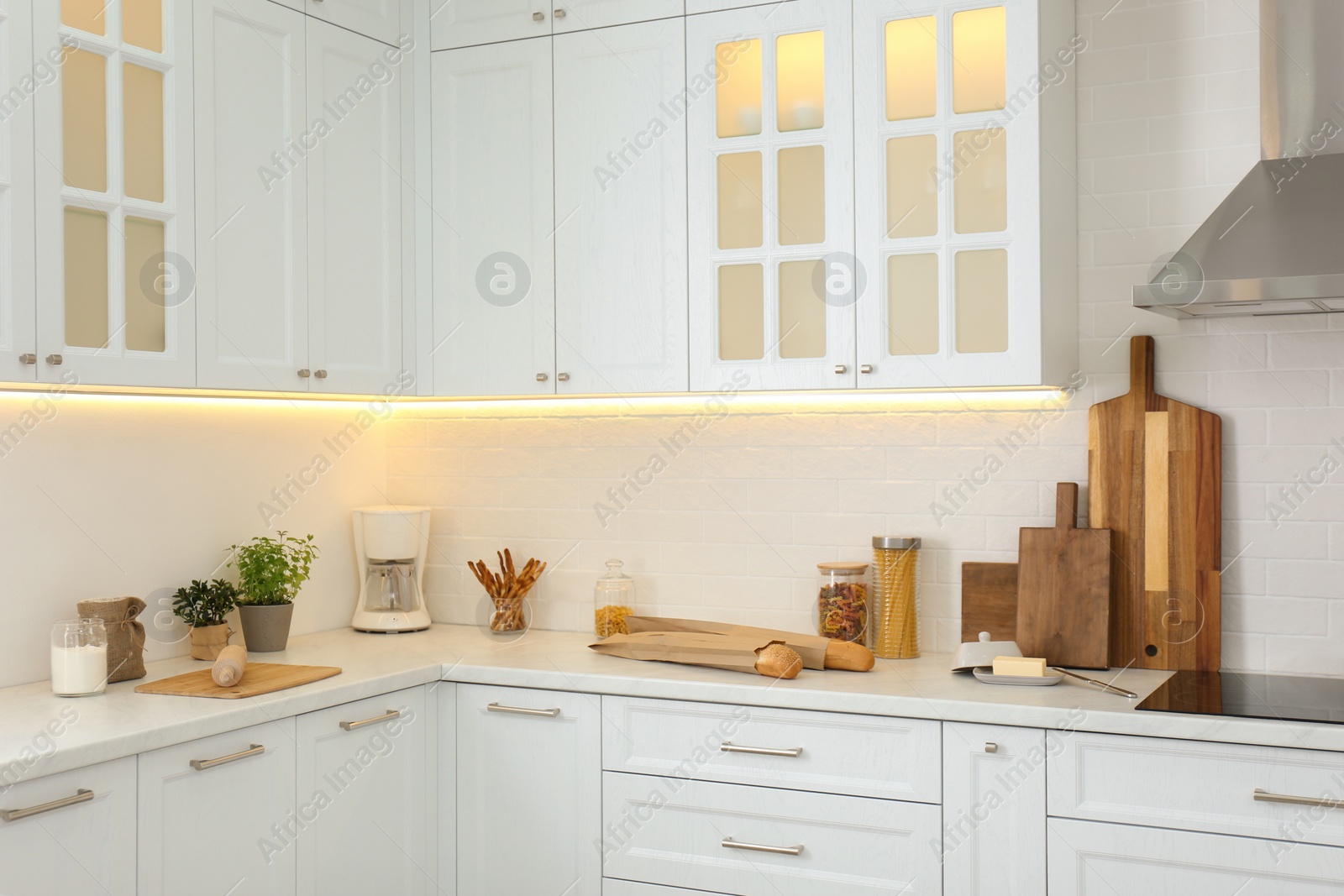 Photo of Modern kitchen interior with stylish white furniture