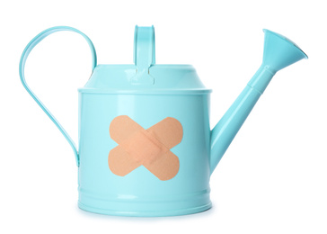 Light blue watering can with sticking plasters isolated on white