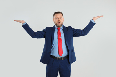 Photo of Portrait of emotional mature man on light grey background