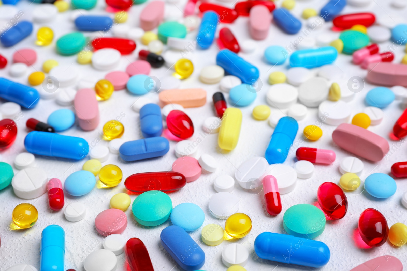 Photo of Different pills and capsules on white background