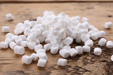 Photo of Delicious white marshmallows on wooden table, closeup