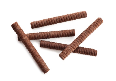 Photo of Delicious chocolate wafer rolls on white background, top view. Sweet food