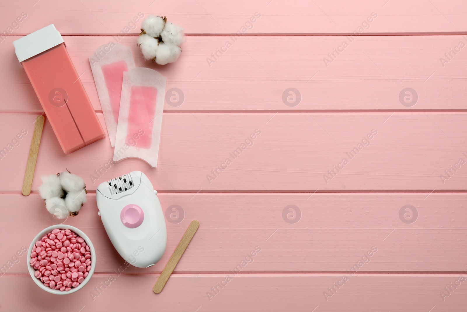 Photo of Set of epilation products on pink wooden table, flat lay. Space for text