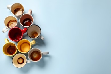 Photo of Many dirty cups after drinking coffee on light blue table, flat lay. Space for text