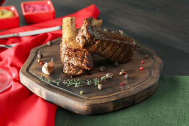 Delicious roasted ribs served on wooden table