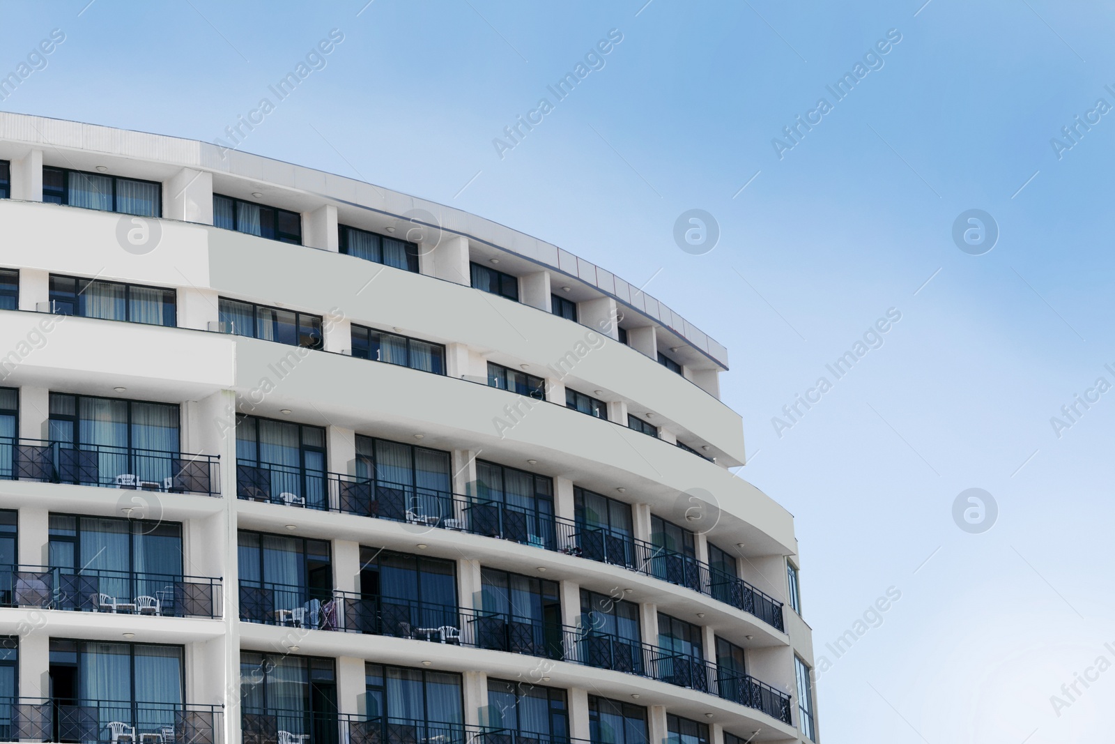 Photo of Exterior of beautiful residential building against blue sky