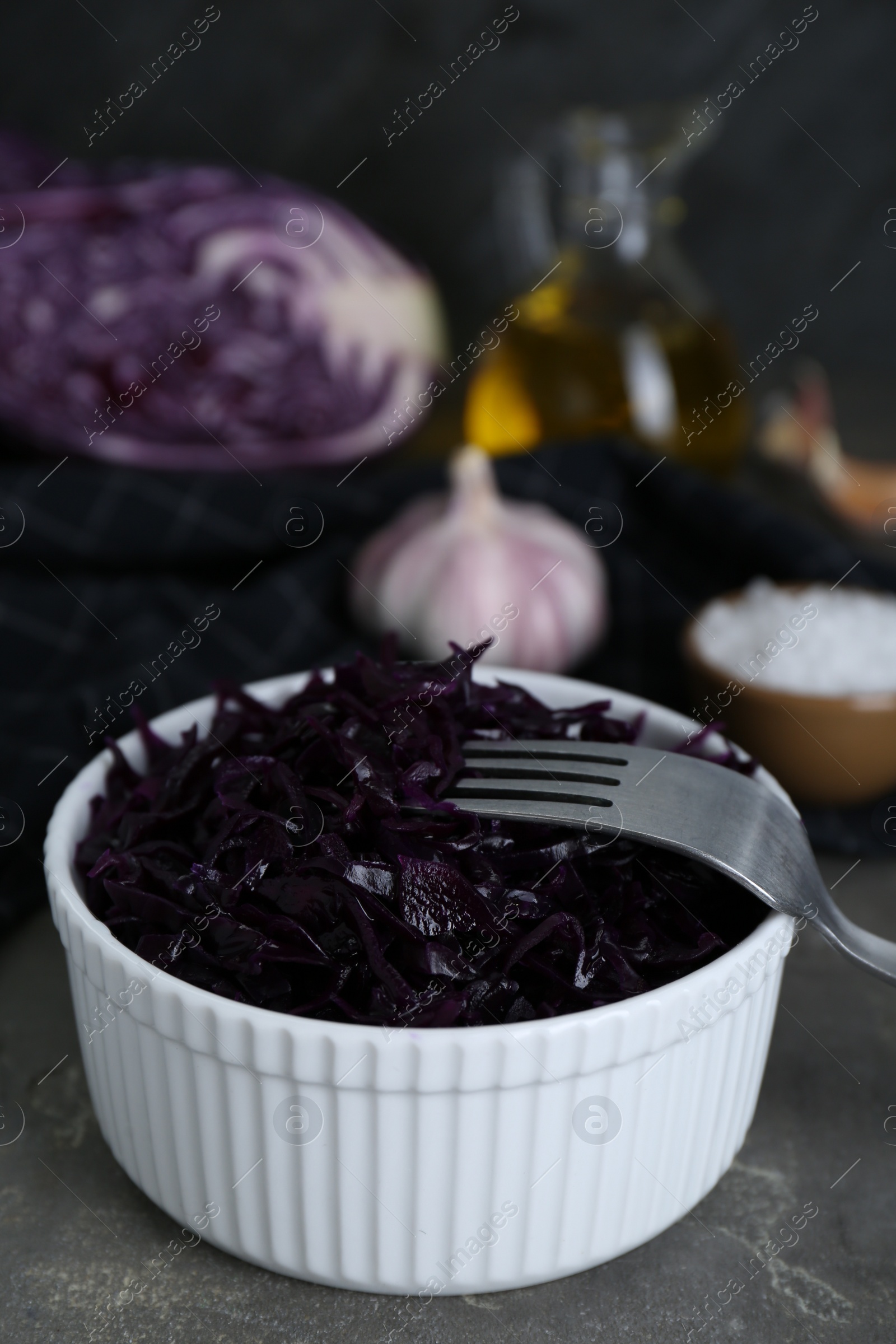 Photo of Tasty red cabbage sauerkraut on light grey table