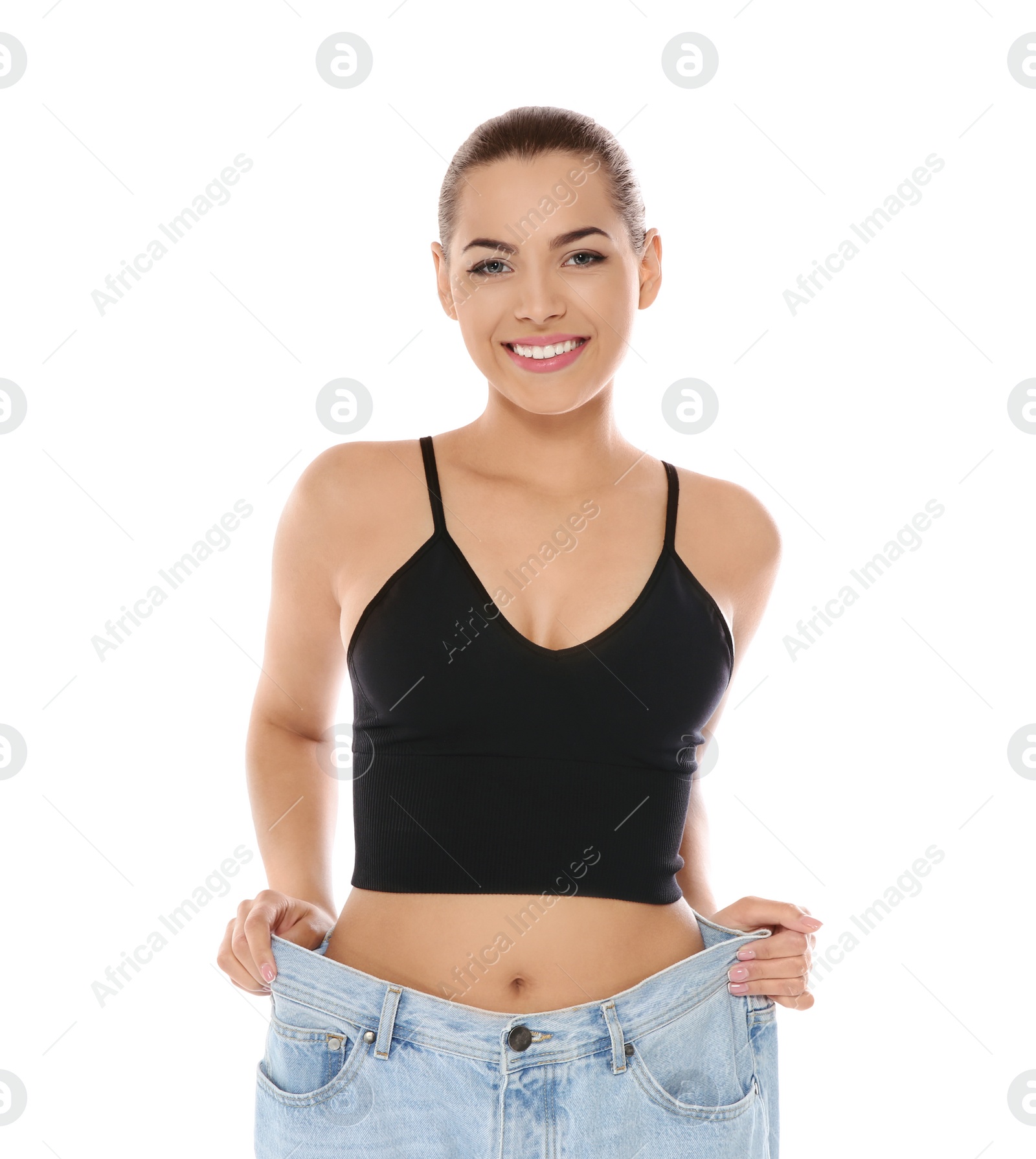 Photo of Slim woman in oversized jeans on white background. Weight loss