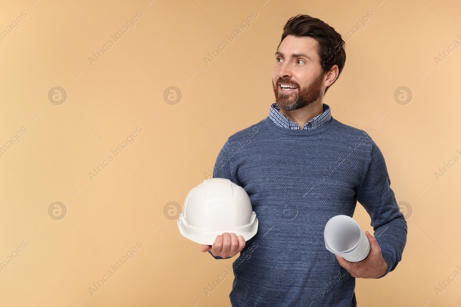 Photo of Architect with hard hat and draft on beige background, space for text