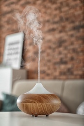 Aroma oil diffuser on table at home. Air freshener