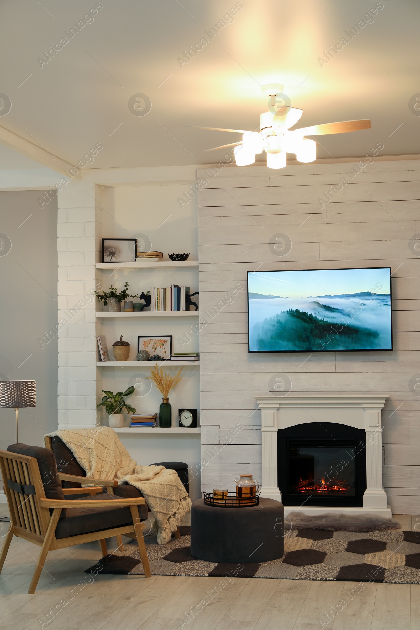 Photo of Cozy living room interior with comfortable armchairs and decorative fireplace