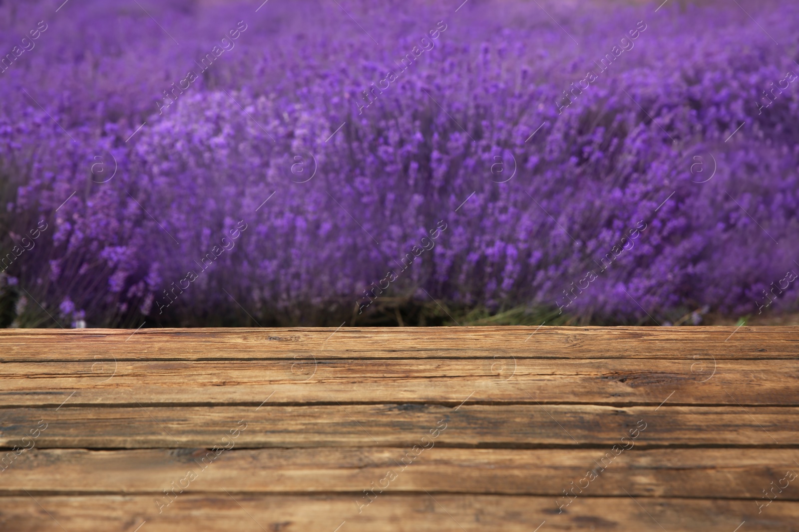 Photo of Empty wooden table in fresh lavender field