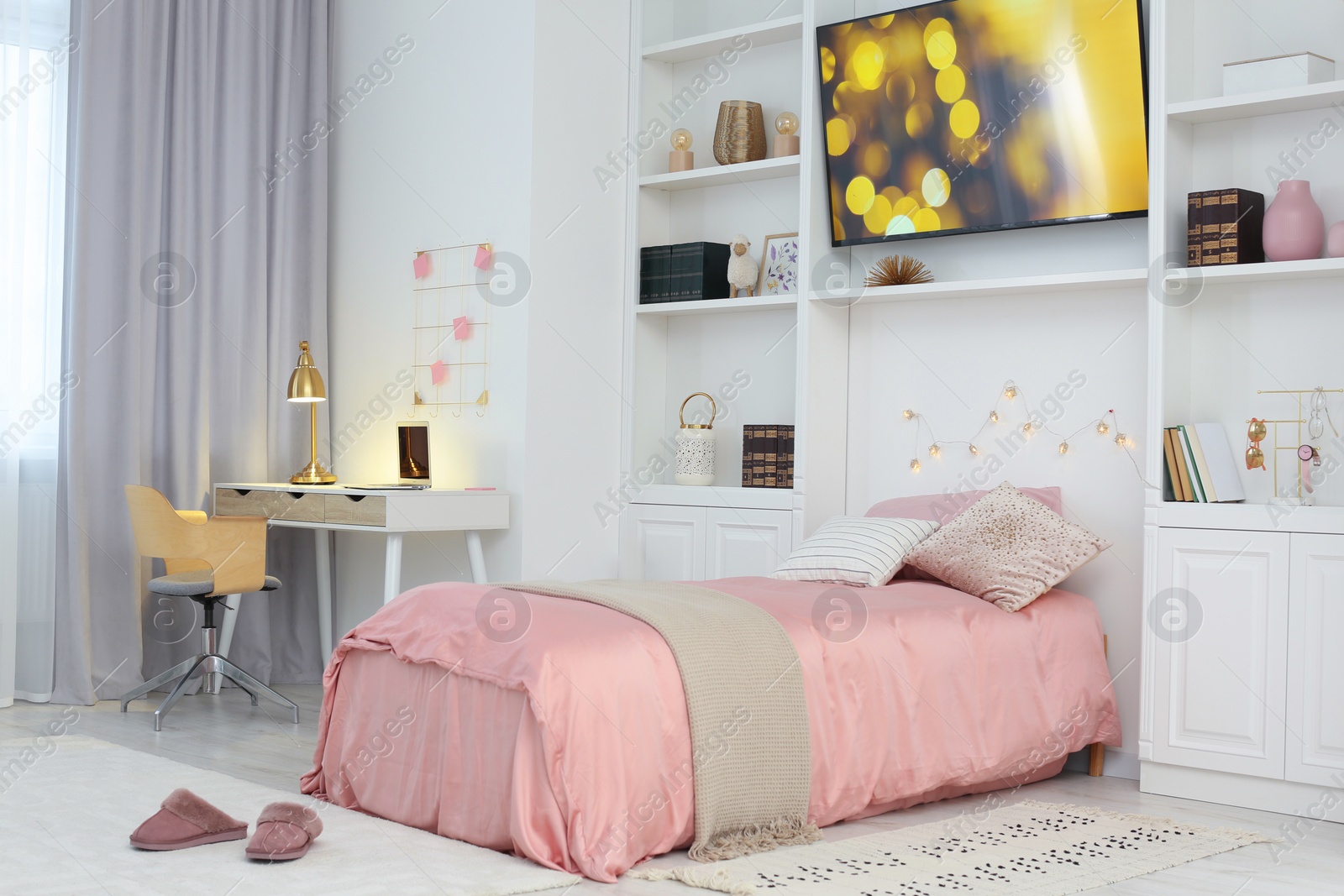 Photo of Stylish teenager's room interior with comfortable bed, workplace and modern TV set