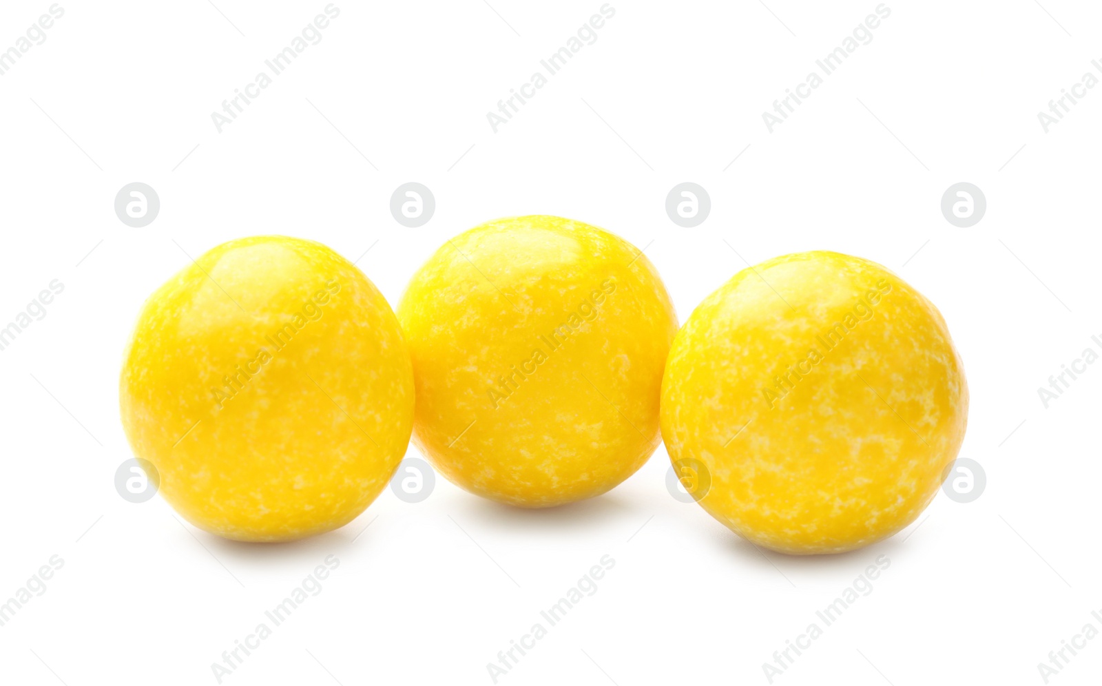 Photo of Tasty small lemon drops isolated on white