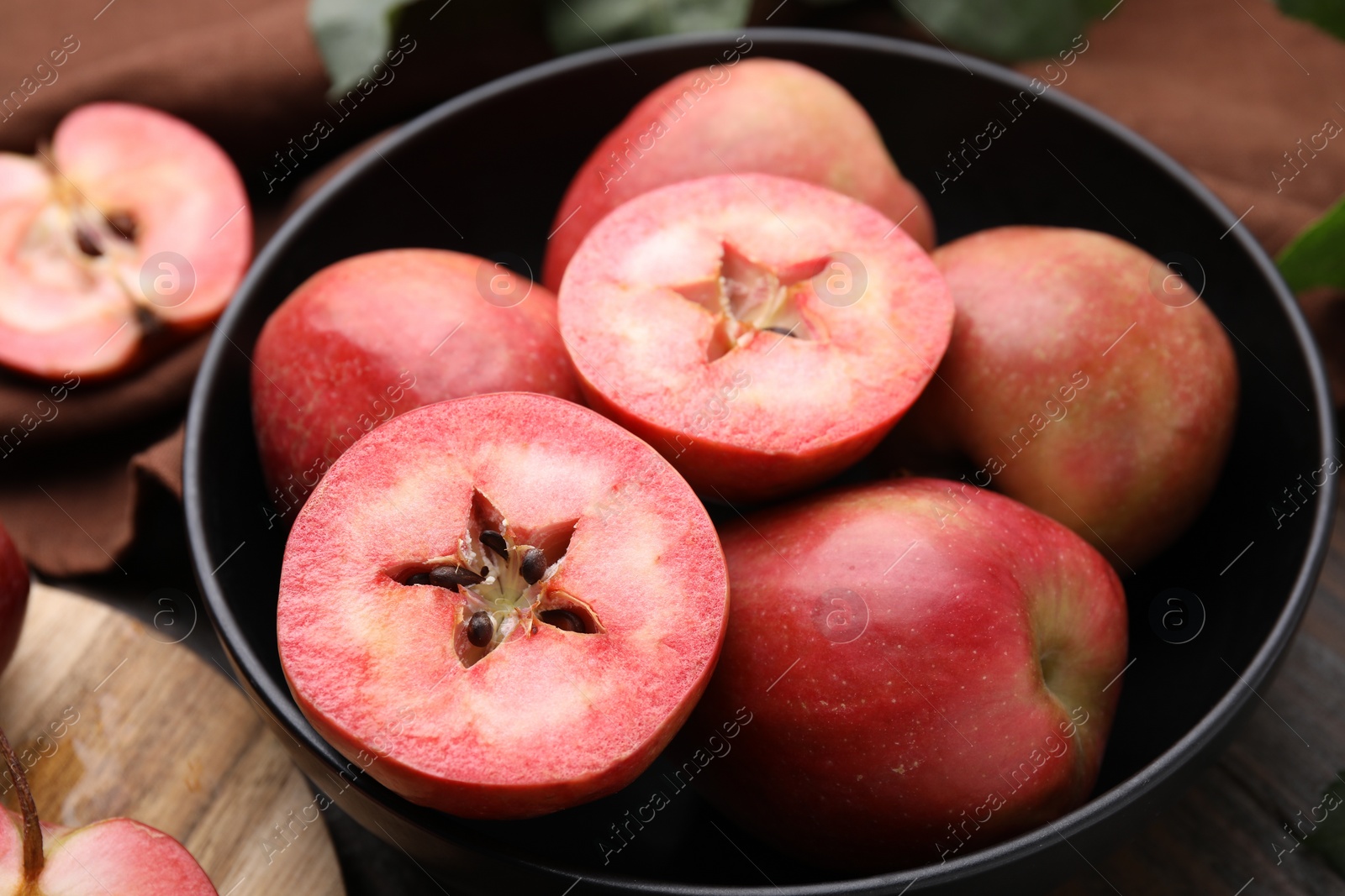 Photo of Tasty apples with red pulp on table, closeup