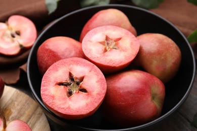 Photo of Tasty apples with red pulp on table, closeup