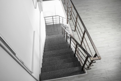 Photo of Stone stairs with metal railing indoors, view through CCTV camera