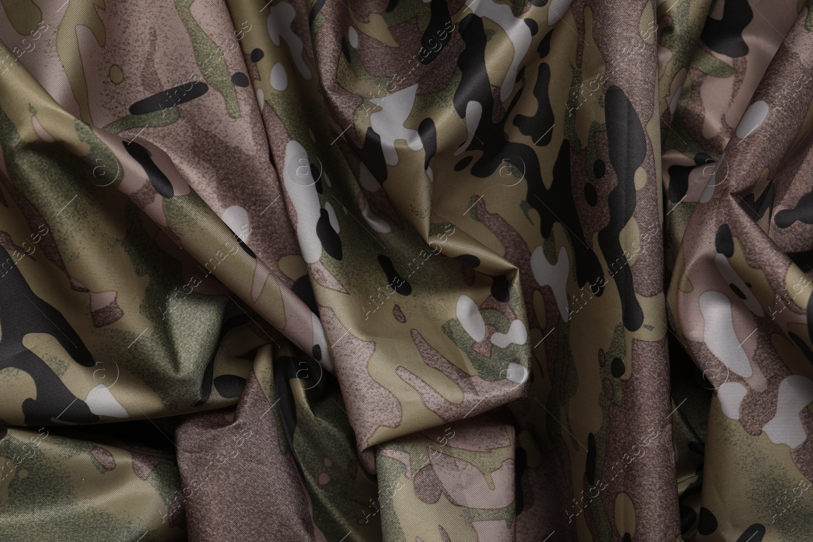 Photo of Texture of crumpled camouflage fabric as background, top view