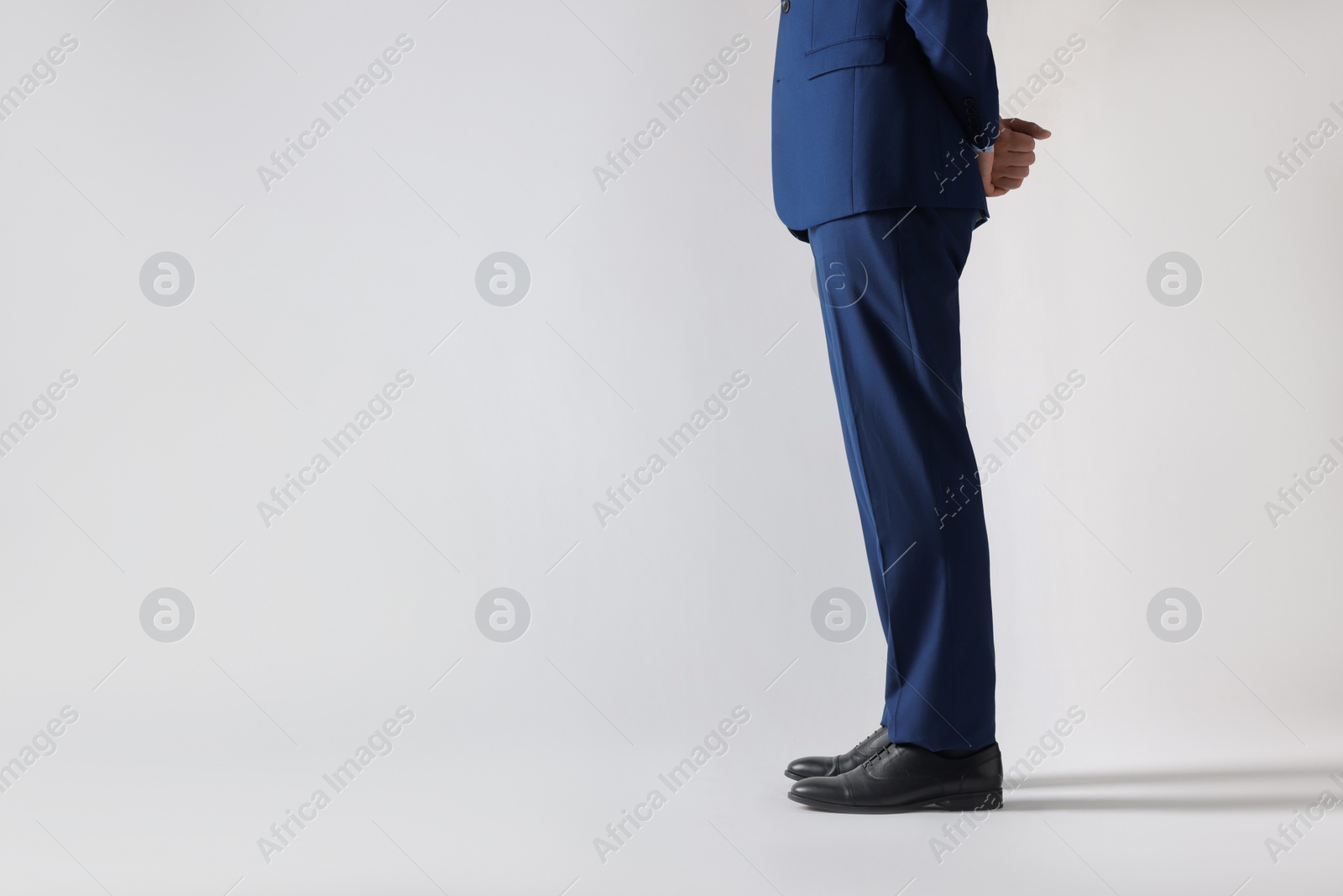 Photo of Businessman in leather shoes on white background, closeup