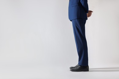 Photo of Businessman in leather shoes on white background, closeup