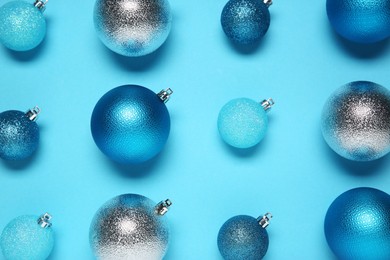 Photo of Christmas balls on light blue background, flat lay