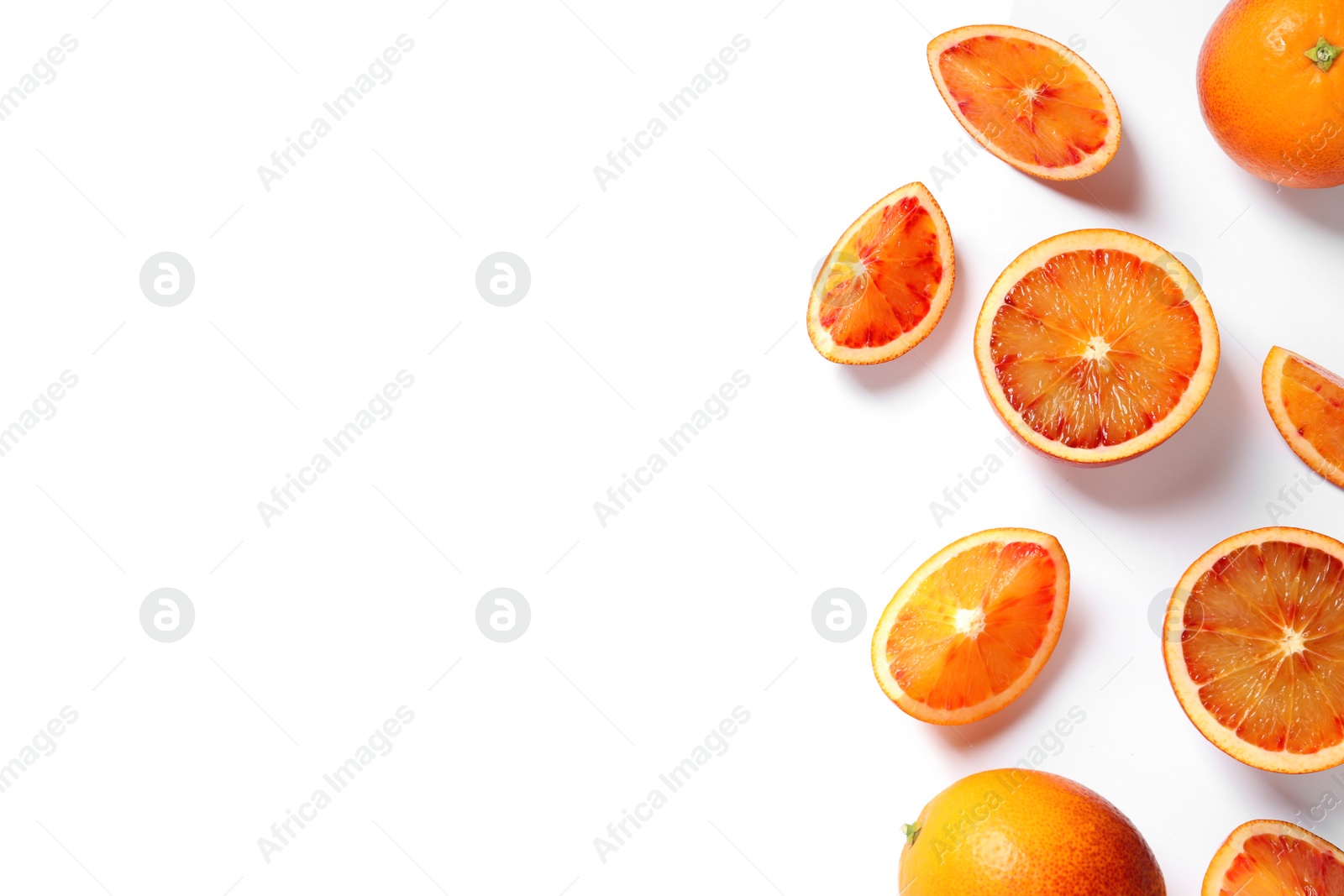 Photo of Fresh bloody oranges on white background, top view. Citrus fruits