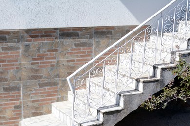 Photo of Beautiful stairs with metal railings near house outdoors