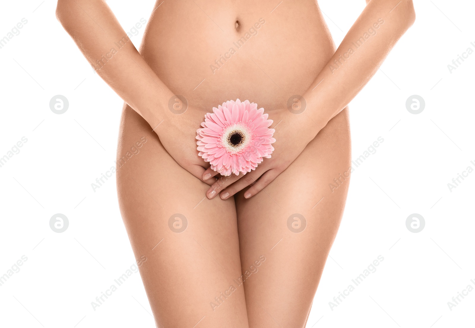 Photo of Woman with gerbera showing smooth skin on white background, closeup. Brazilian bikini epilation