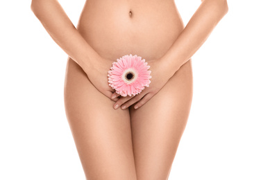 Woman with gerbera showing smooth skin on white background, closeup. Brazilian bikini epilation